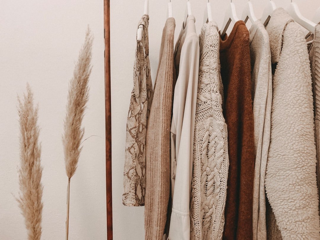 Minimal wardrobe with neutral-toned clothing on a rack