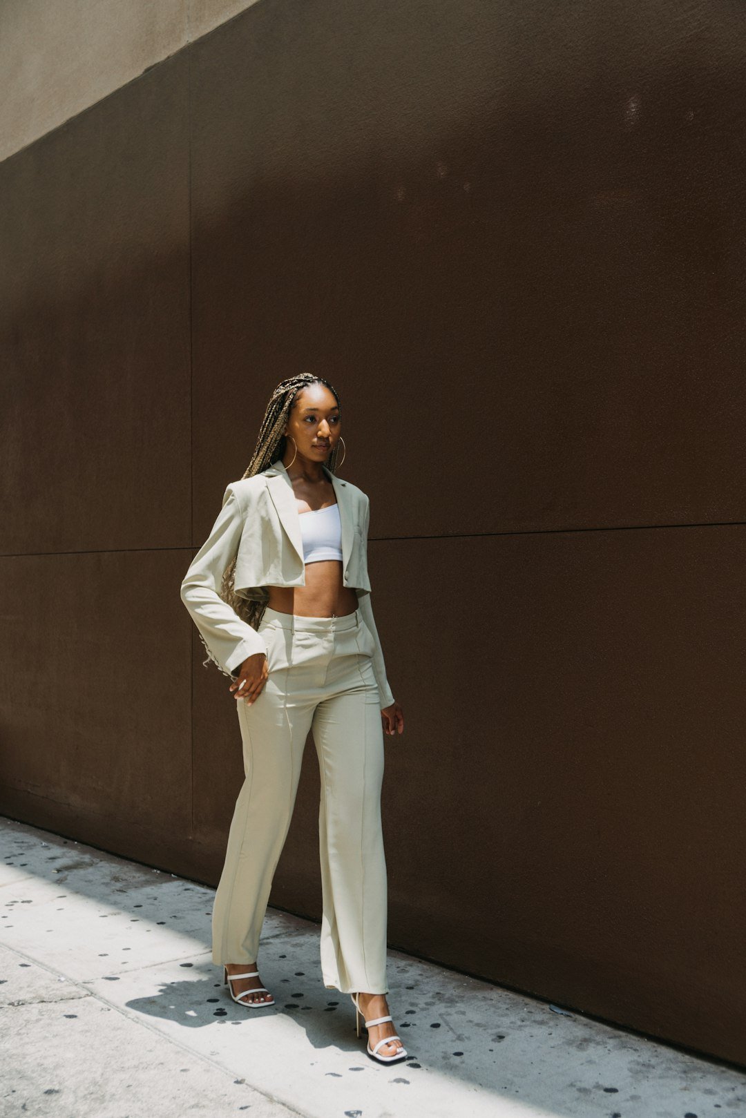 Woman wearing wide-leg trousers and a white top, minimal styling